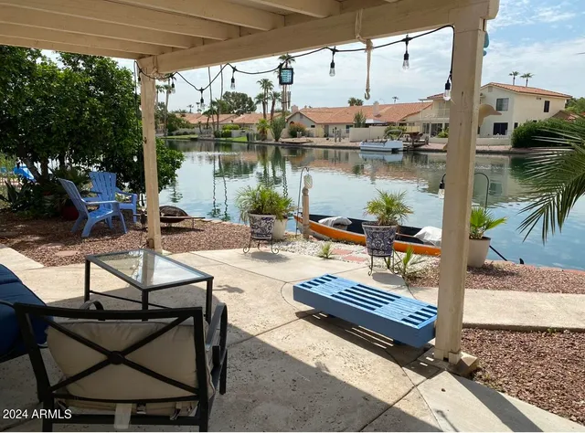 a view of swimming pool with outdoor seating and plants