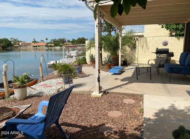 a view of a swimming pool with outdoor seating and plants