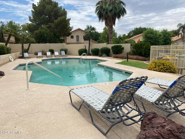 swimming pool view with a seating space