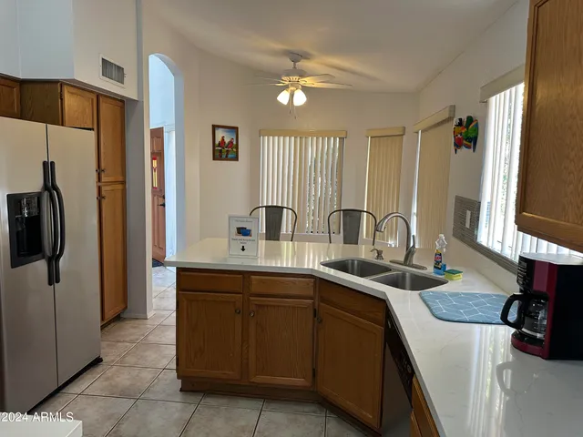 a kitchen with a sink and a refrigerator