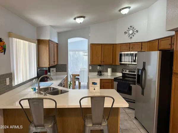 a kitchen with stainless steel appliances a refrigerator sink and cabinets