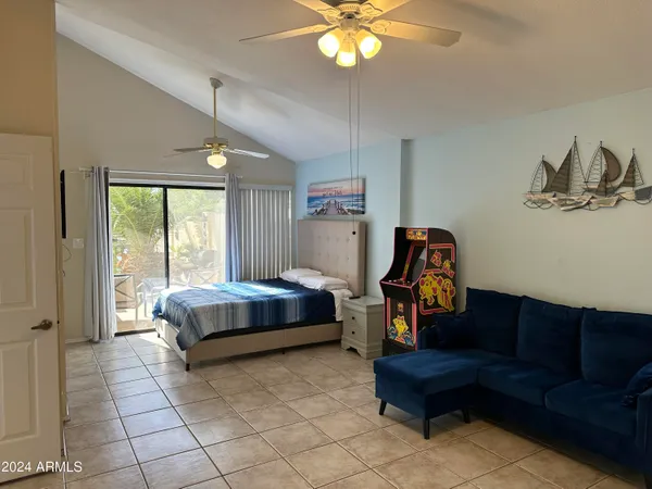 a bedroom with a bed and a chandelier