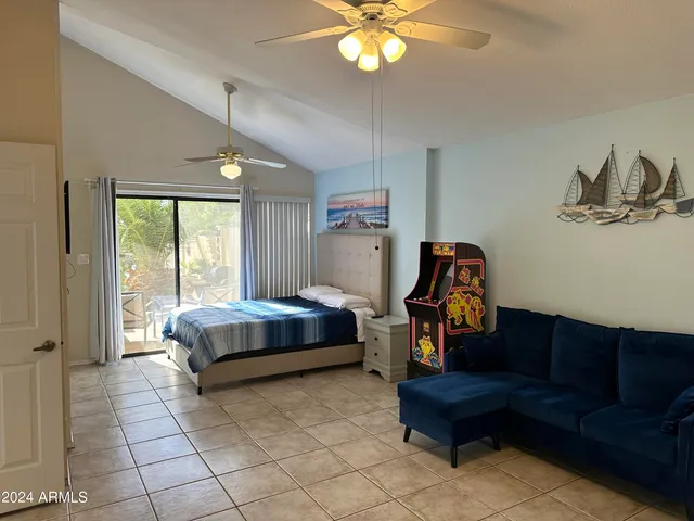 a bedroom with a bed and a chandelier