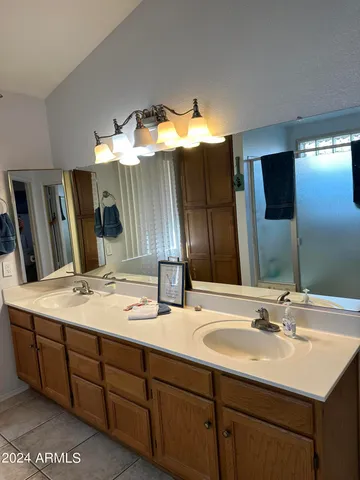 a bathroom with a double vanity sink and a mirror