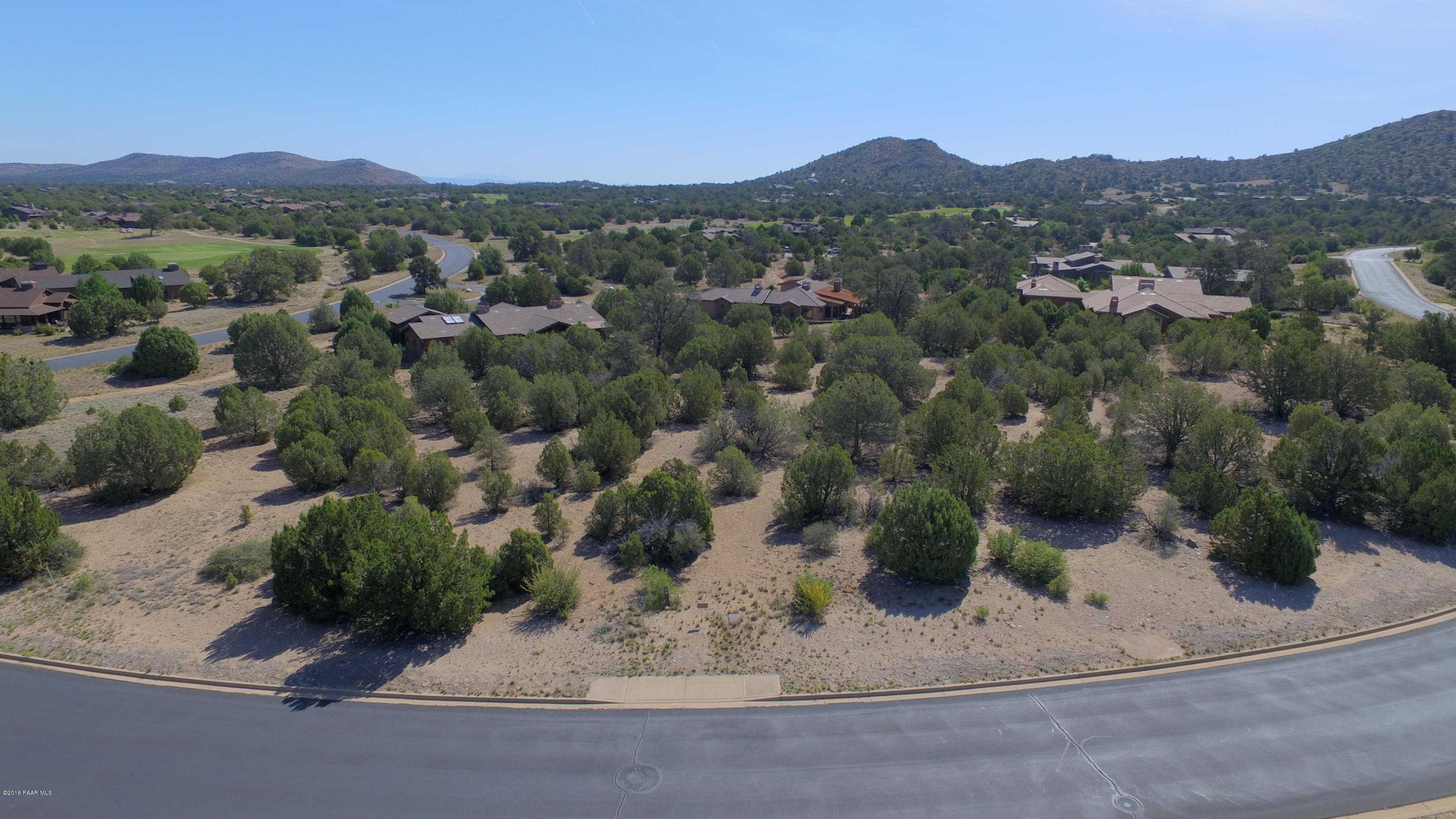 5760 West Three Forks Road Prescott, AZ 86305 - Photo 1 of 2 an aerial view of a house with a yard and mountain view in back