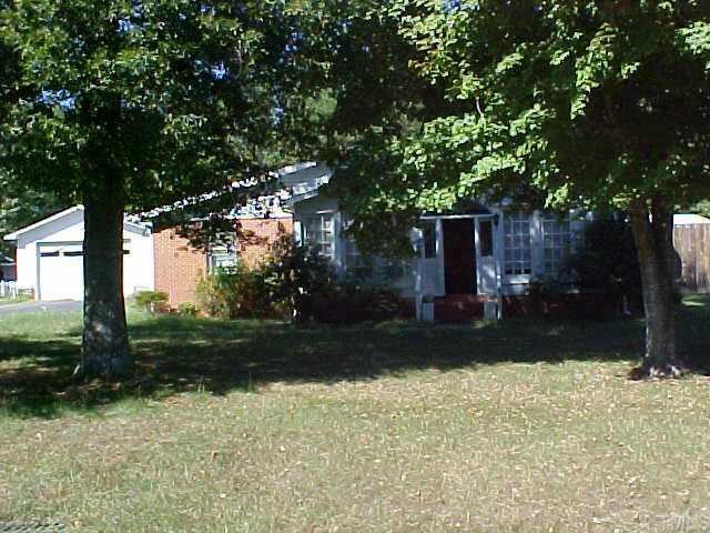 a view of a backyard with plants and trees
