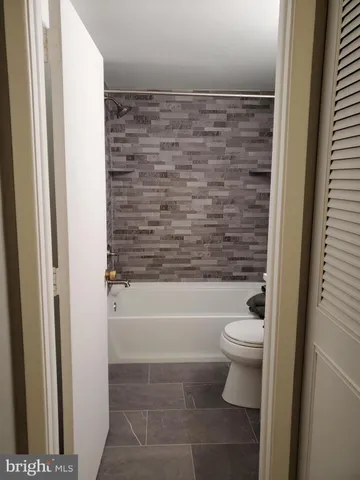 a bathroom with a sink a toilet and a bathtub