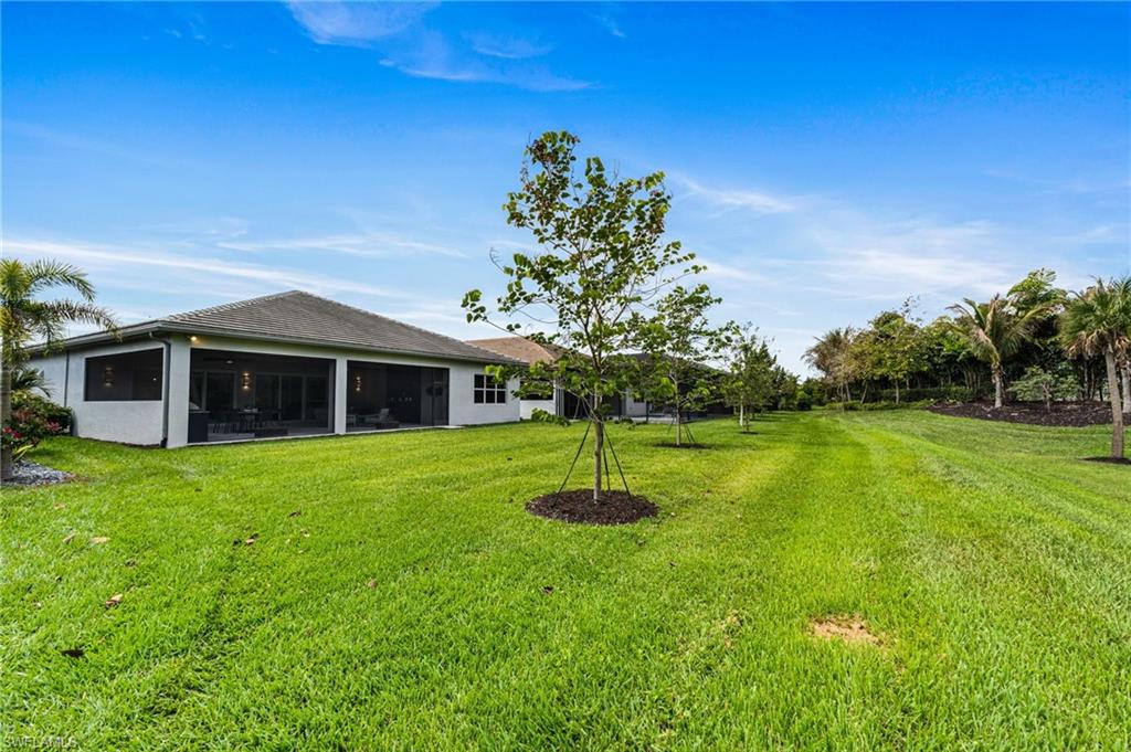 12033 Azalea Way Naples, FL 34120 - Photo 30 of 46 Perfectly positioned on a unique lot with view of rare extended greenspace and serene preserve, this home offers an extraordinary sense of privacy and tranquility.