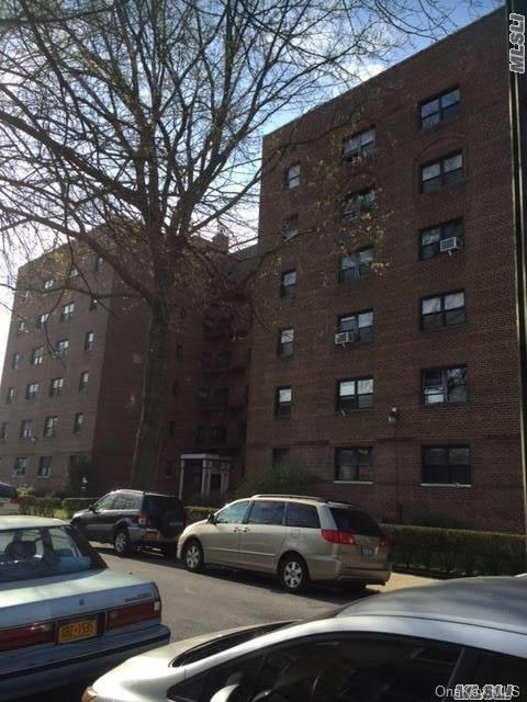 147-14 84th Road, Unit 2A Queens, NY 11435 - Photo 1 of 1 a view of street with parked cars