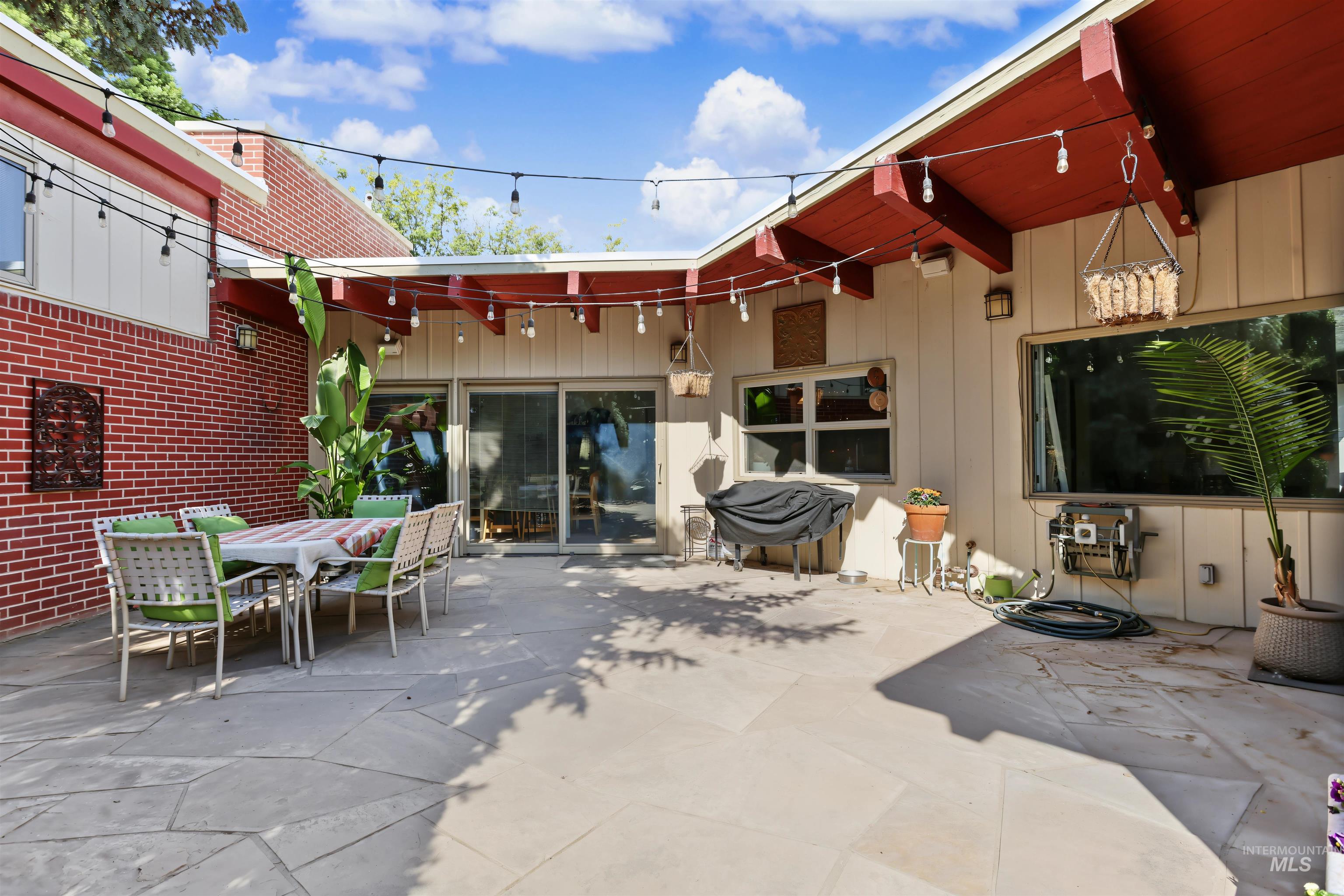 508 East Elm Avenue Parma, ID 83660 - Photo 46 of 50 Expansive patio featuring flagstone paving, a brick exterior wall, and sliding glass doors
