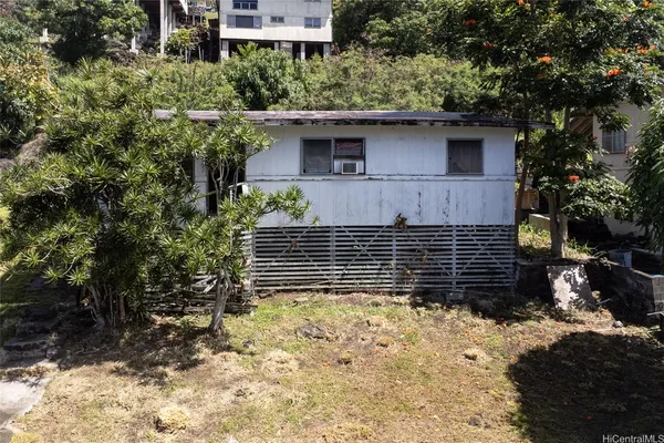 a yellow house with trees in front of it
