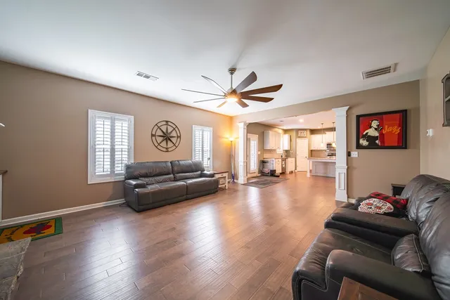 a living room with furniture and a wooden floor