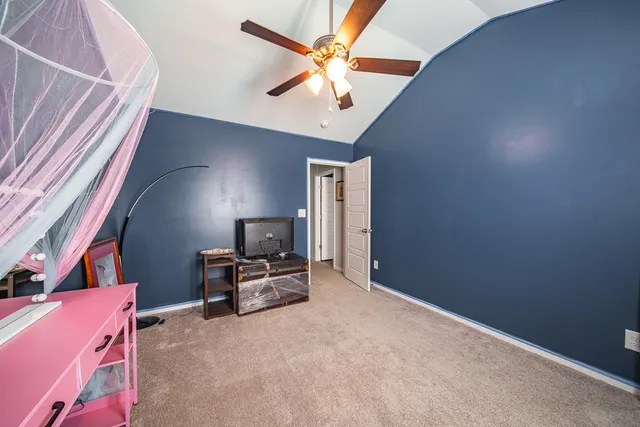 a workspace with furniture and a ceiling fan