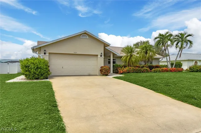 a front view of house with yard and trees