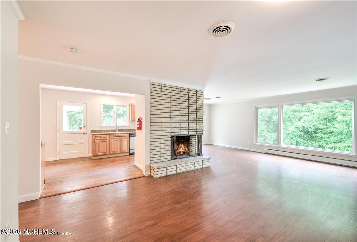 699 Aldrich Road Howell, NJ 07731 - Photo 7 of 23 a view of an empty room with a fireplace and a window