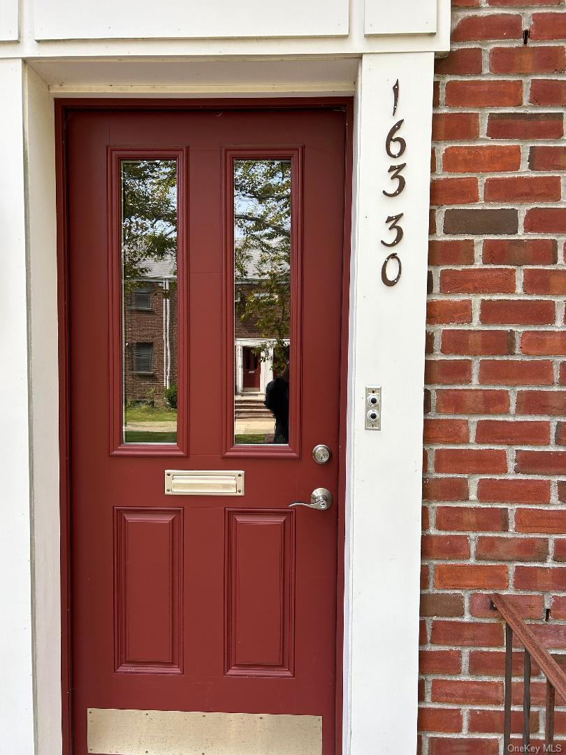 a view of a door and brick wall