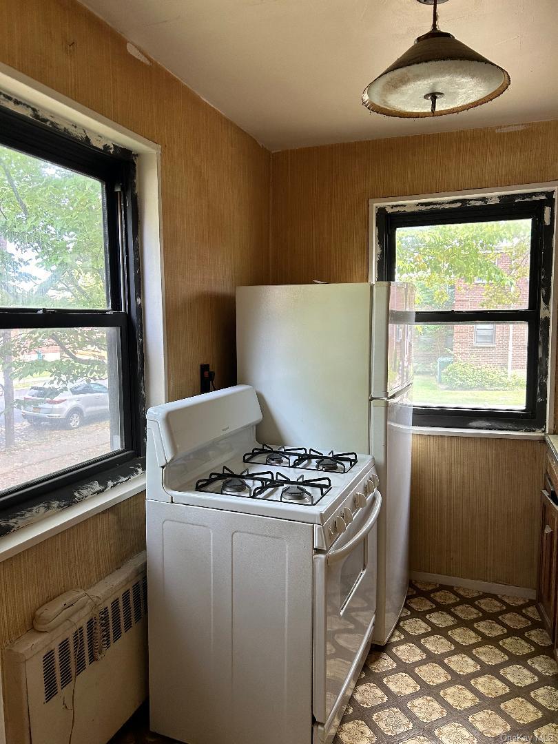 163-30 17th Avenue, Unit 4297 Queens, NY 11357 - Photo 14 of 17 a kitchen with stainless steel appliances a stove and a microwave
