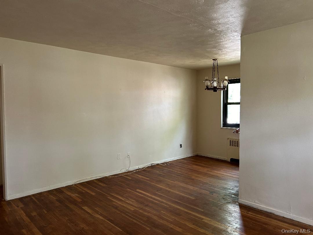 163-30 17th Avenue, Unit 4297 Queens, NY 11357 - Photo 3 of 17 an empty room with wooden floor and windows