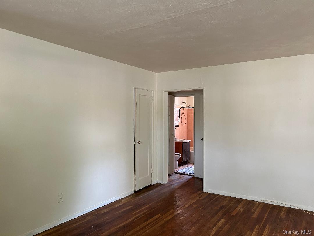 163-30 17th Avenue, Unit 4297 Queens, NY 11357 - Photo 5 of 17 a view of an empty room with wooden floor and a window