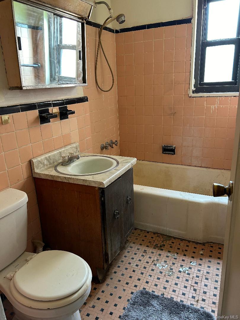 163-30 17th Avenue, Unit 4297 Queens, NY 11357 - Photo 6 of 17 a bathroom with a sink a toilet and shower