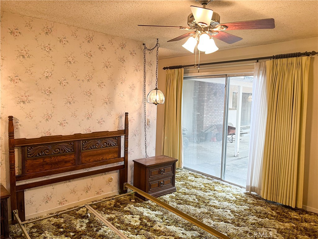 3665 Woodson Avenue Corning, CA 96021 - Photo 16 of 30 a view of a bedroom with wooden floor and a ceiling fan