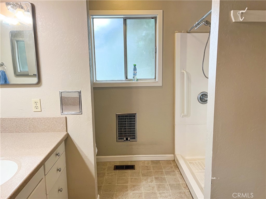 3665 Woodson Avenue Corning, CA 96021 - Photo 19 of 30 a bathroom with a sink and a mirror