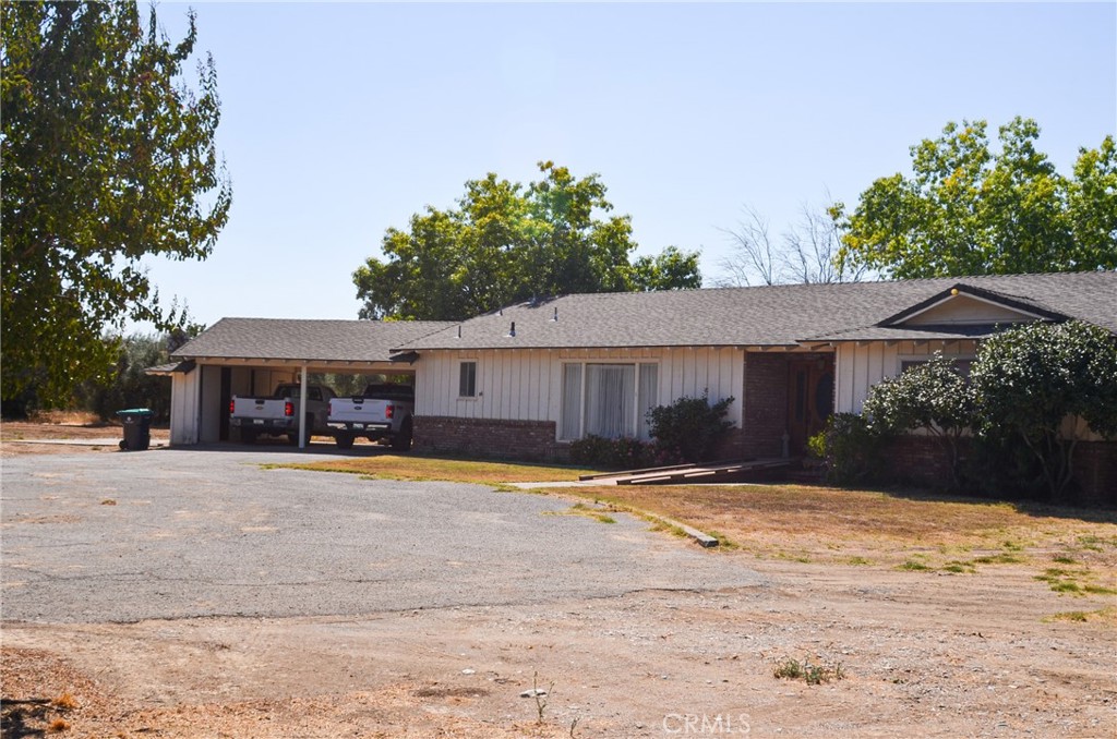 3665 Woodson Avenue Corning, CA 96021 - Photo 2 of 30 a front view of a house with a yard and garage
