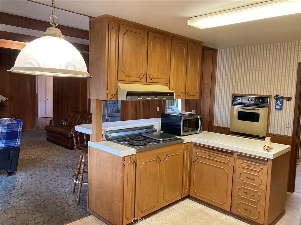 3665 Woodson Avenue Corning, CA 96021 - Photo 8 of 30 a kitchen with cabinets appliances and a dining table
