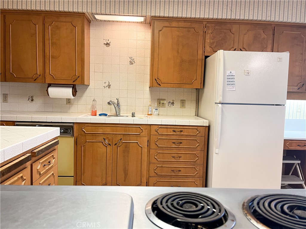 3665 Woodson Avenue Corning, CA 96021 - Photo 9 of 30 a kitchen with a refrigerator and a sink