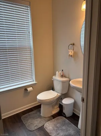a bathroom with a toilet and a window