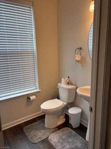 a bathroom with a toilet and a window