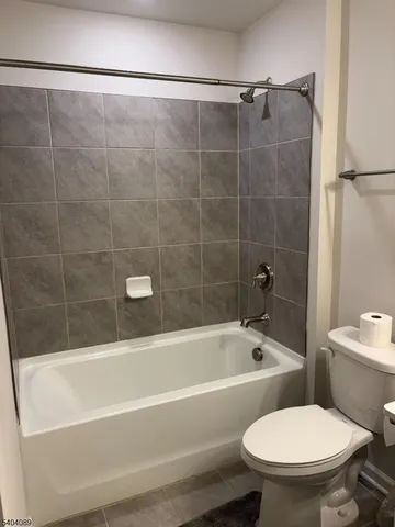 a bathroom with a toilet bathtub and shower
