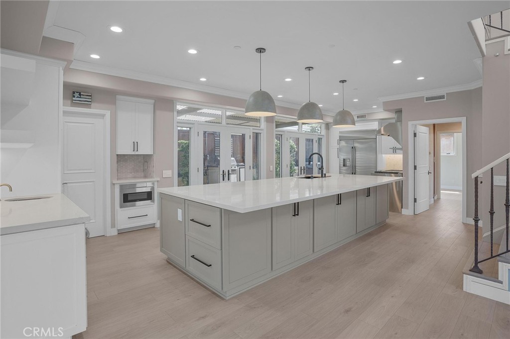 a kitchen with stainless steel appliances kitchen island granite countertop a large counter top and stainless steel appliances