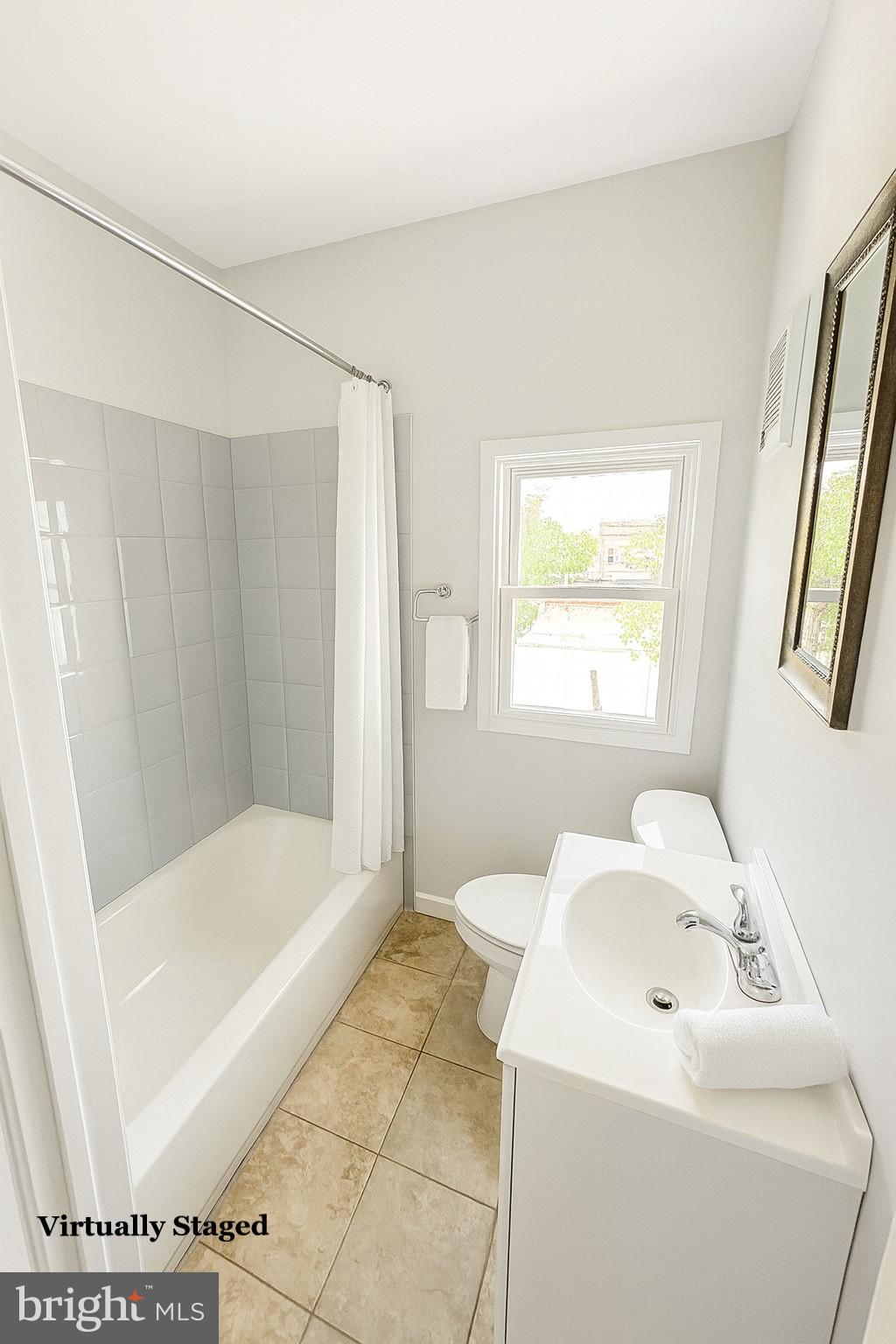 1017 West Huntingdon Street, Unit 3 Philadelphia, PA 19133 - Photo 5 of 8 a bathroom with a sink a toilet and shower
