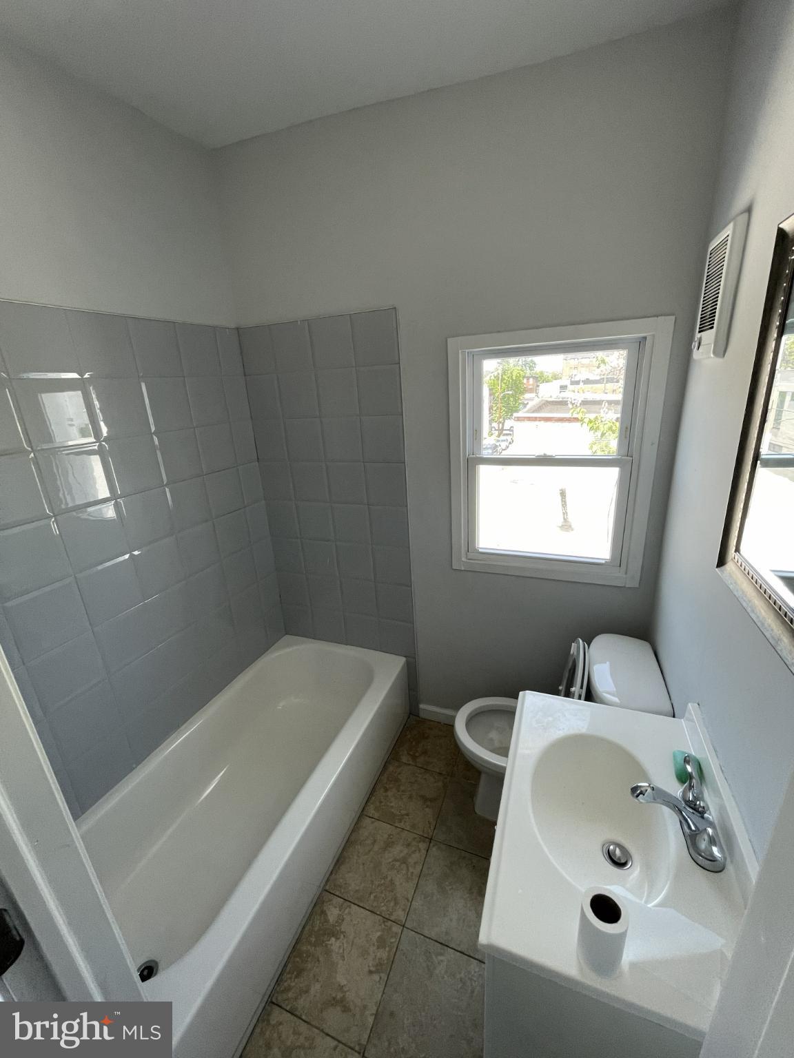 1017 West Huntingdon Street, Unit 3 Philadelphia, PA 19133 - Photo 6 of 8 a bathroom with a sink a window and shower