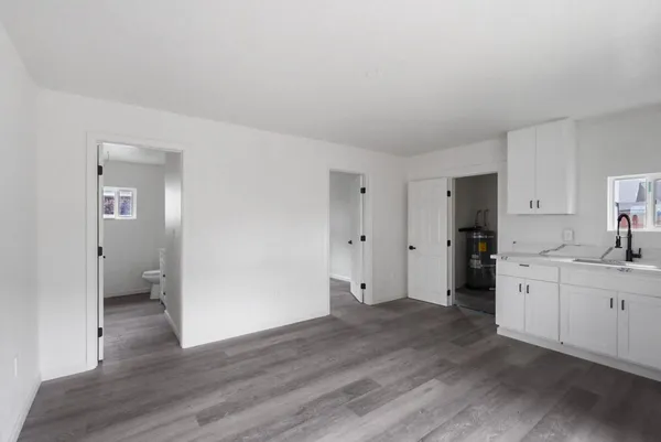 a view of a kitchen with wooden floor and a sink