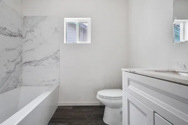 a bathroom with a toilet and a bathtub