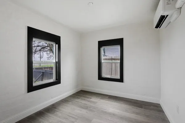 an empty room with windows and closet