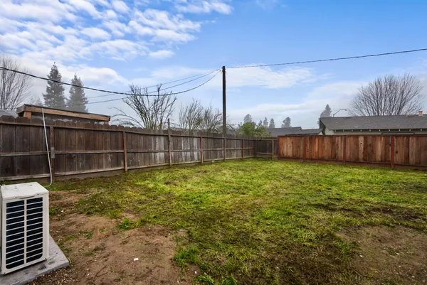 a view of a backyard with brick wall