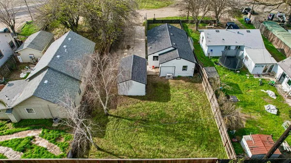 an aerial view of a house with a yard