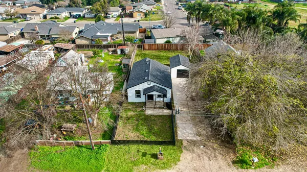 an aerial view of a house with a yard
