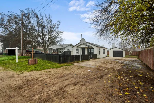 a front view of house with yard and trees