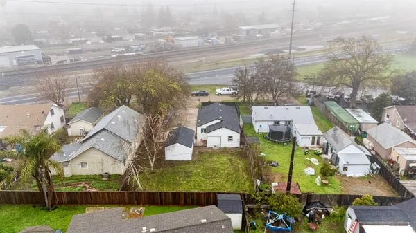 an aerial view of residential houses with outdoor space