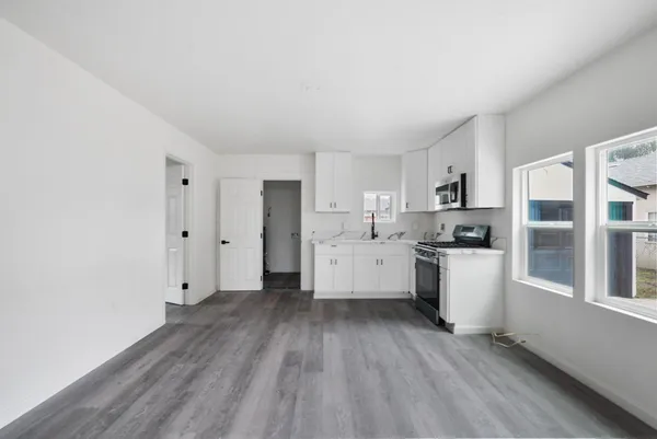 a view of a kitchen with wooden floor