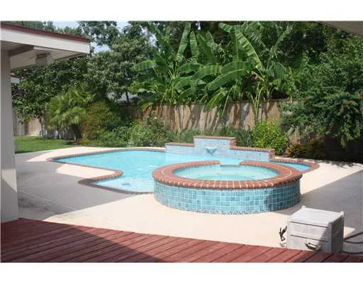 a view of a swimming pool with a yard