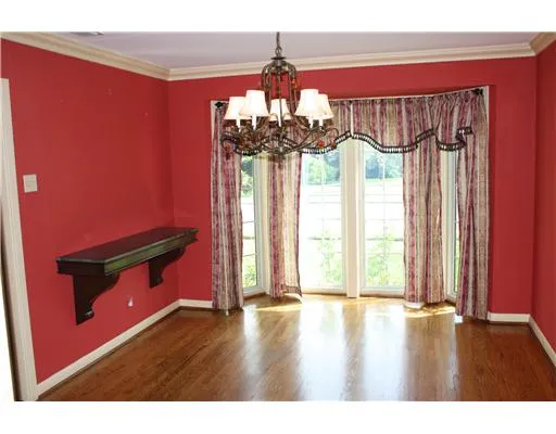 a view of a room with wooden floor and a window