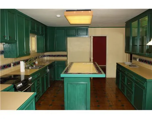 a kitchen with a stove a sink and a microwave