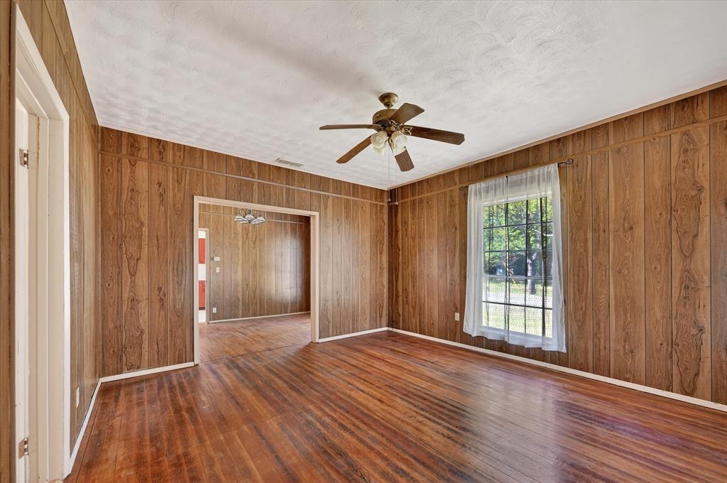 800 South Jefferson Street Pilot Point, TX 76258 - Photo 7 of 27 a view of empty room with wooden floor and fan