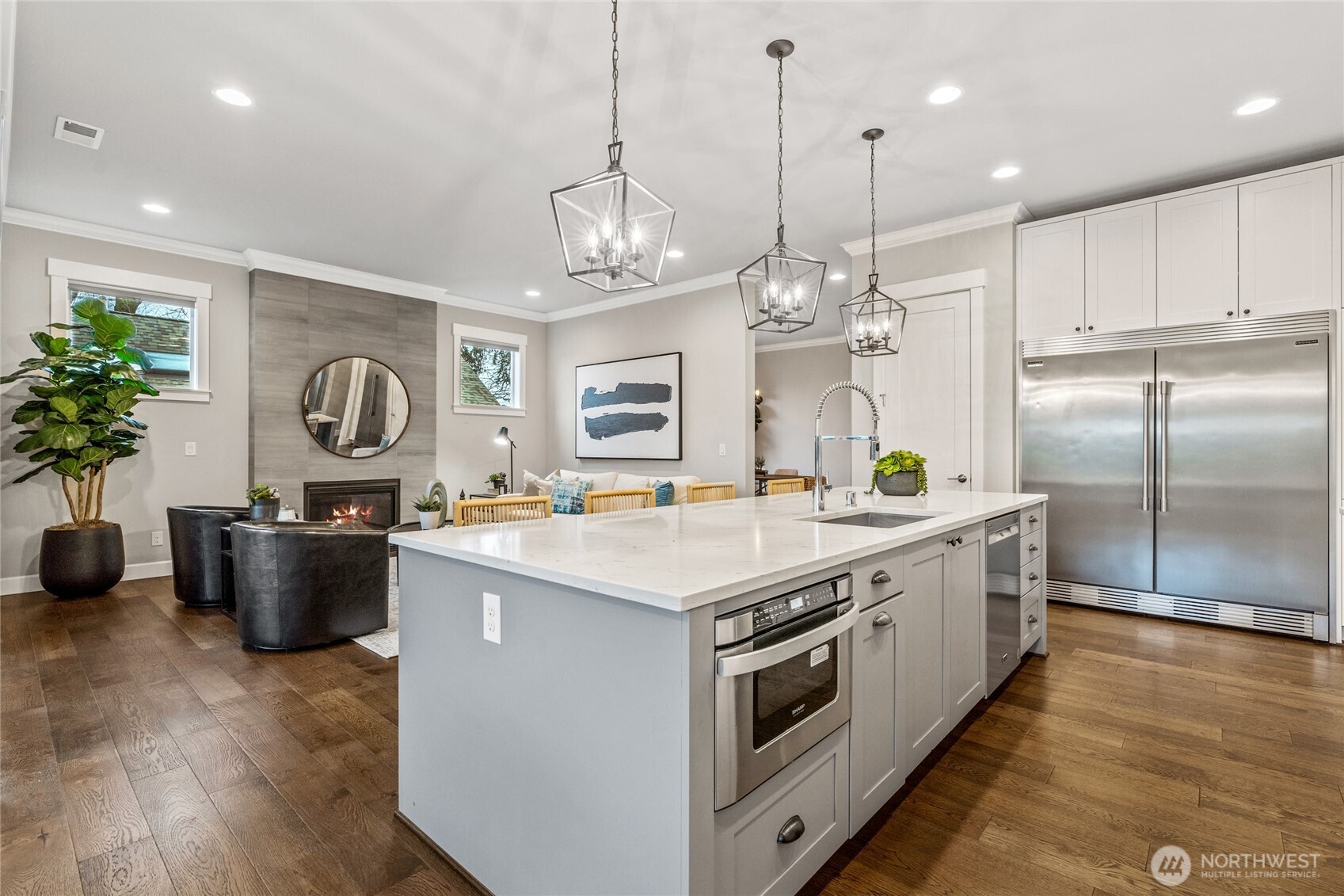 3303 Northeast 7th Street Renton, WA 98056 - Photo 7 of 25 a large kitchen with kitchen island a large counter top a sink stainless steel appliances and cabinets