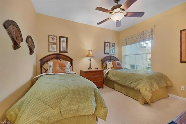 a bedroom with two beds and a chandelier
